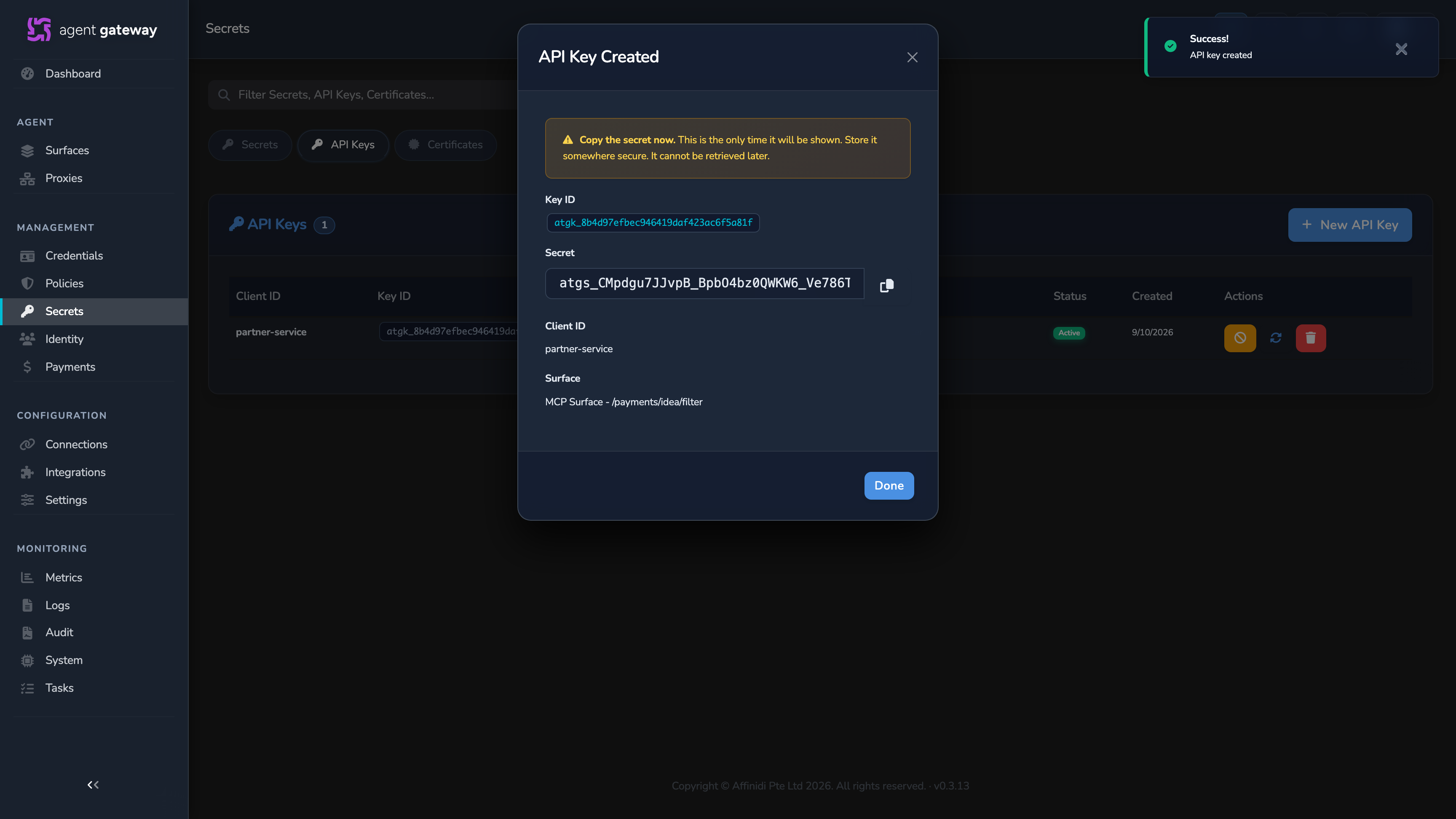 API Keys tab with the key list behind the API Key Created confirmation modal, showing the Key ID and one-time Secret value